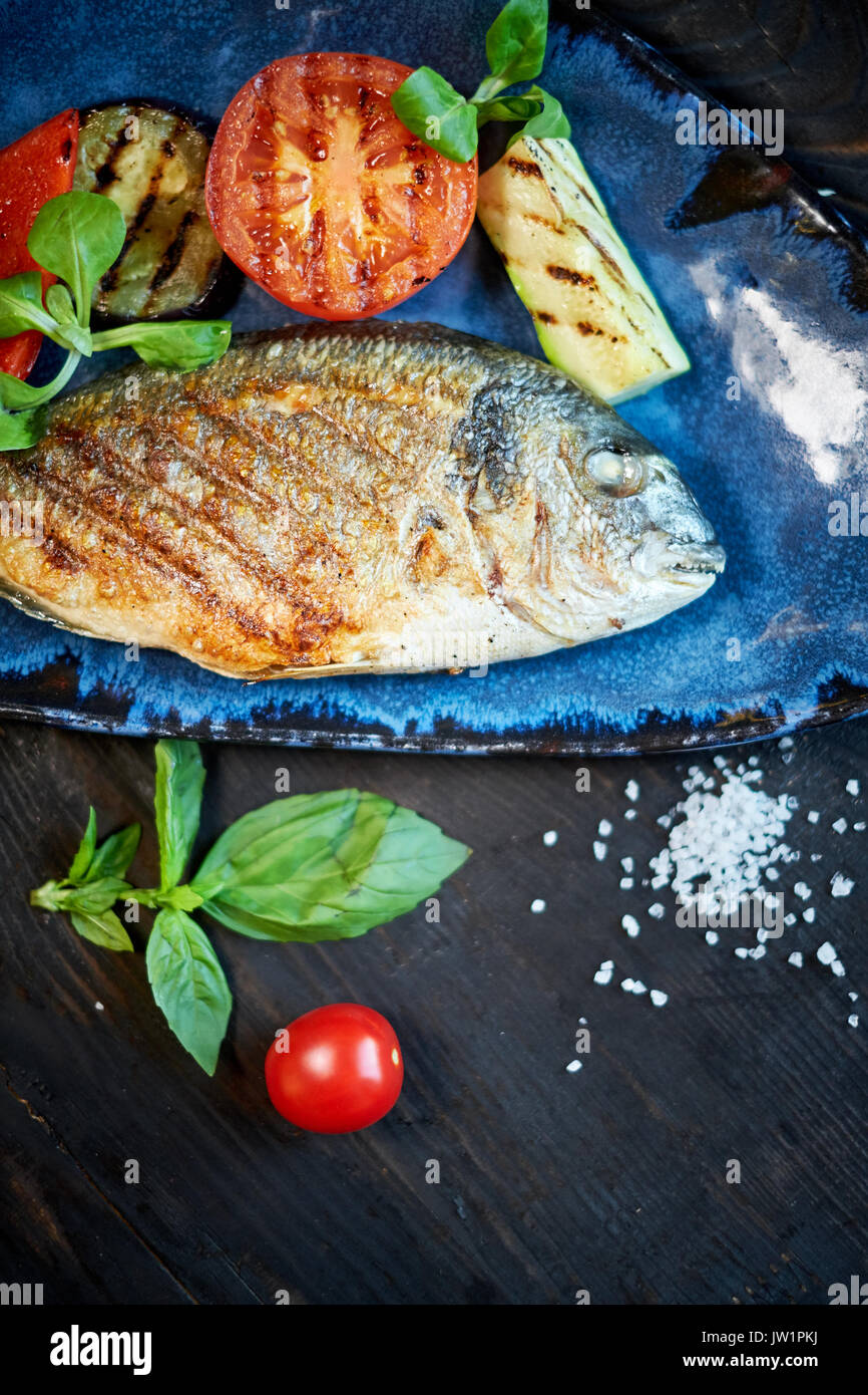 Grilled Fish dish - roasted fish and vegetables jpg Stock Photo - Alamy