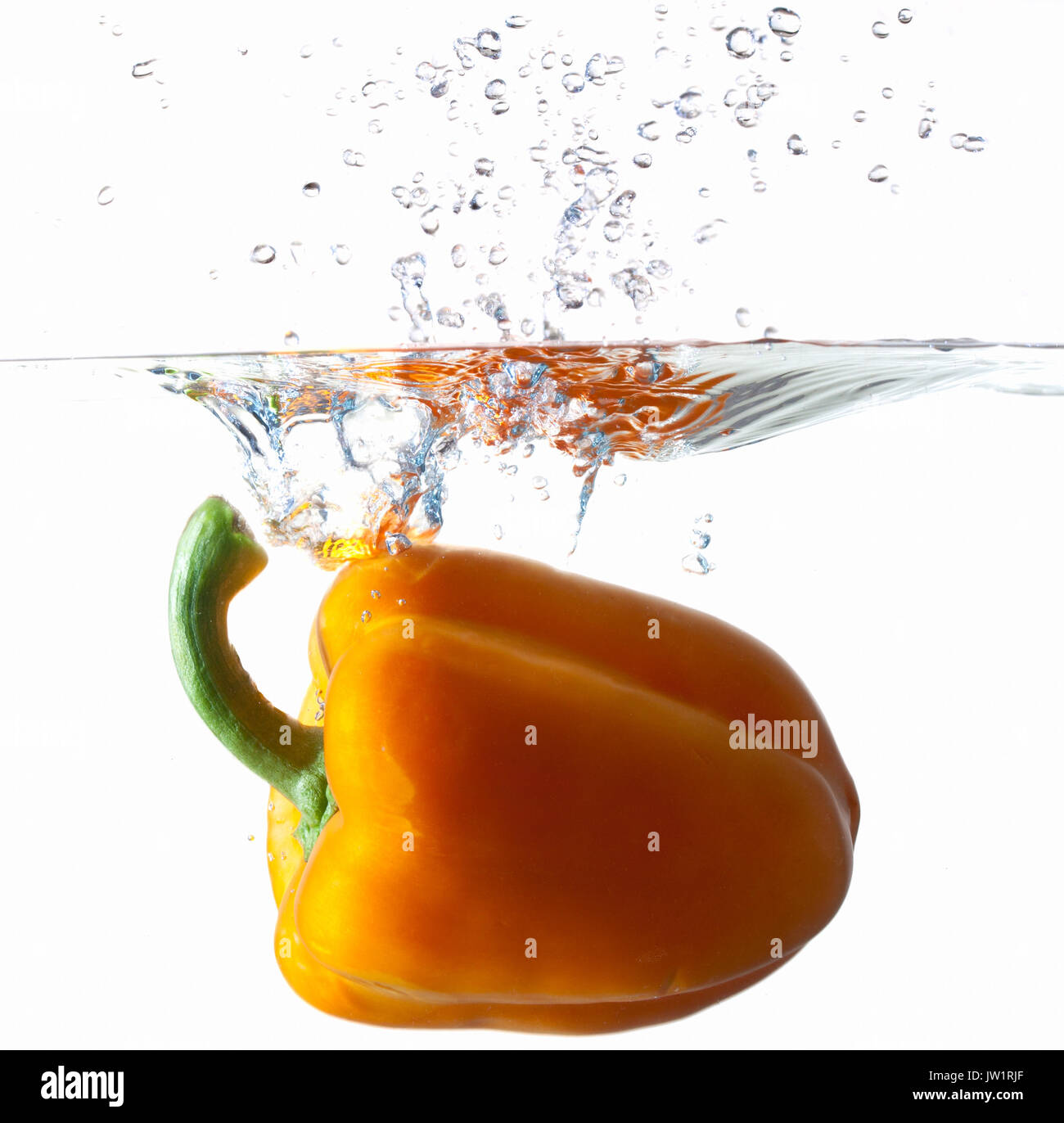 Orange Bell Pepper Dropping Into Water Stock Photo Alamy