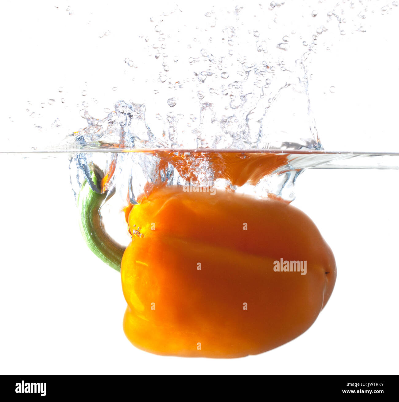 Orange Bell Pepper Dropping Into Water Stock Photo Alamy