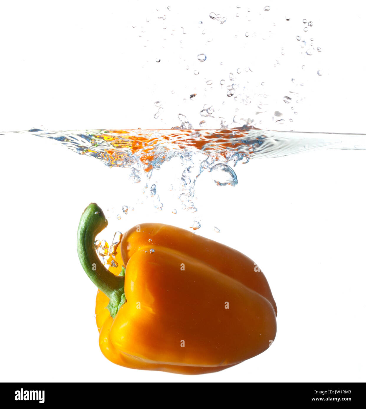 Orange Bell Pepper Dropping Into Water Stock Photo Alamy