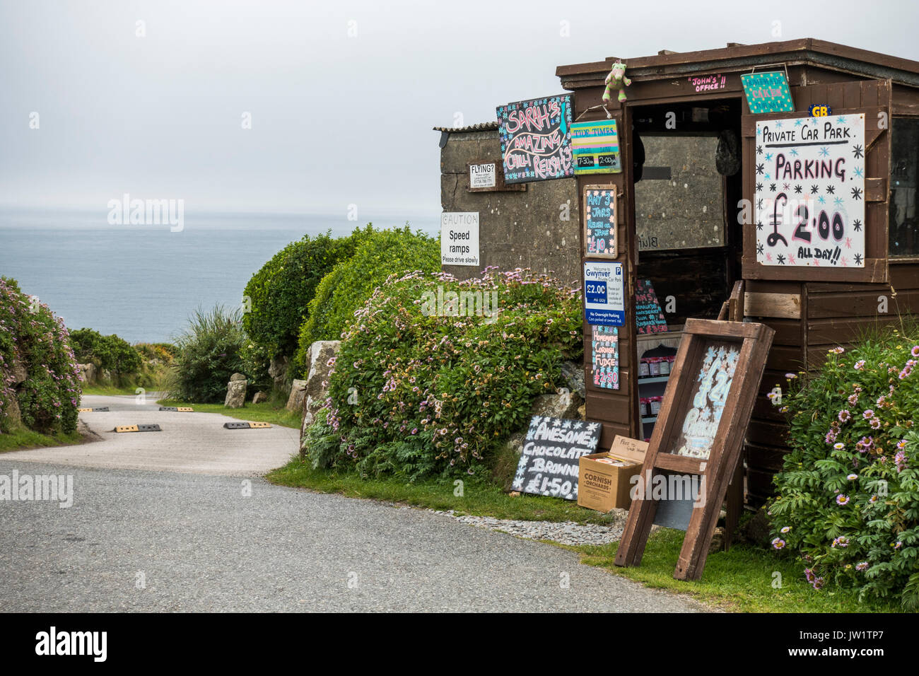 Shed adorned with various items, serving as a collection point for a private car park near to Gwynver Beach, near Penzance, Cornwall, England, UK. Stock Photo