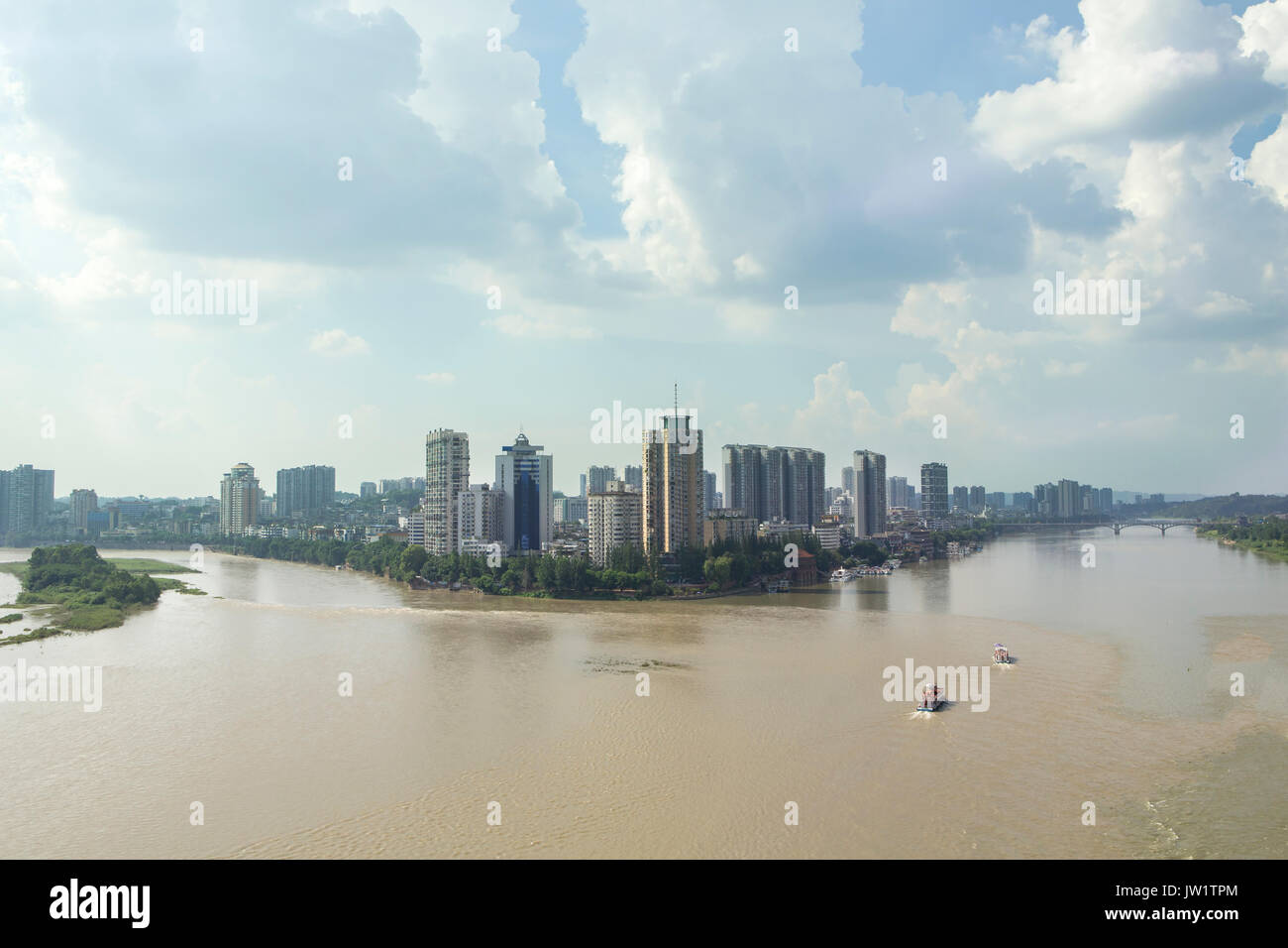View of Leshan Sichuan province China. City located on the confluence of two big rivers; the Dadu and Min. Seen here muddy and in full flood. Stock Photo