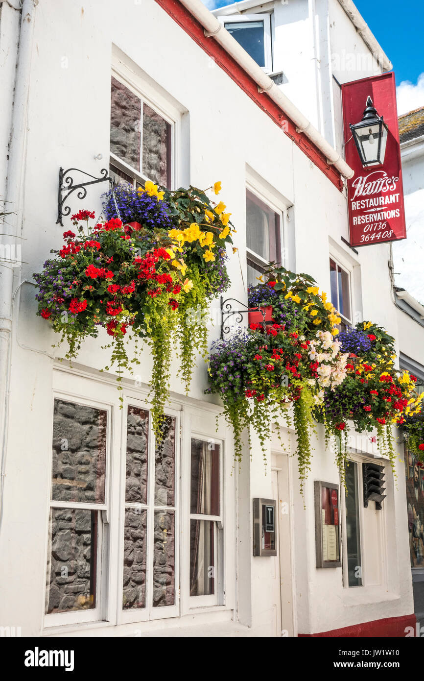 Flower display outside Harris's restaurant down a side street in Penzance, Cornwall, England, UK. Stock Photo