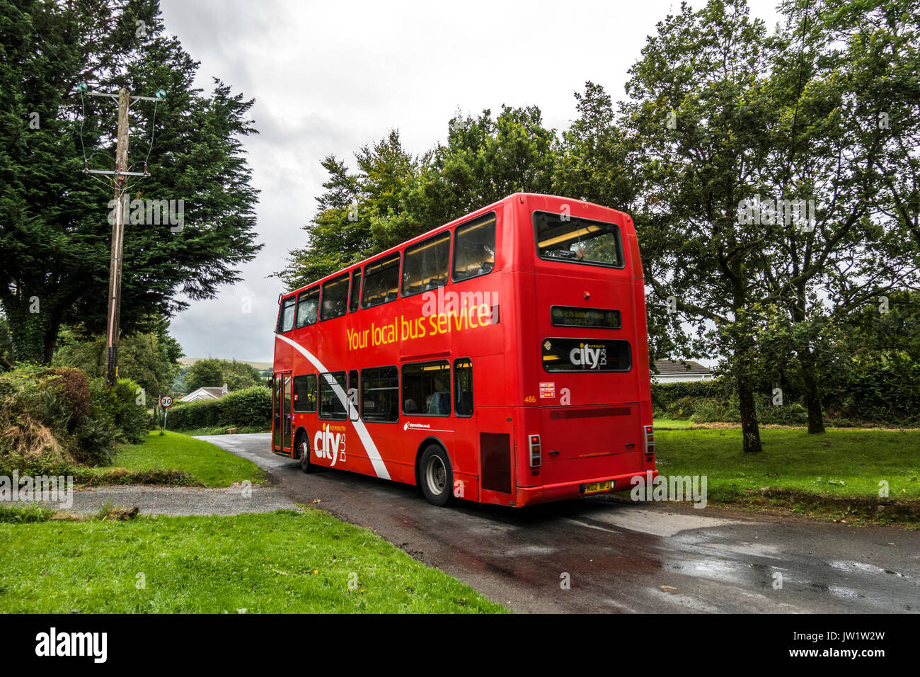 Red no. 46 double decker bus in Lydford, near Okehampton, Devon, England, UK. Stock Photo