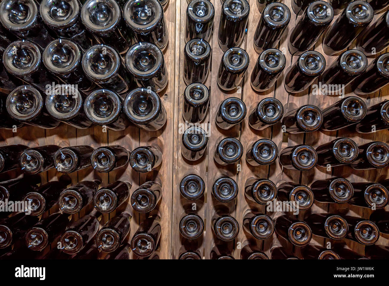 Bottoms of wine bottles stacked in cellar Stock Photo Alamy