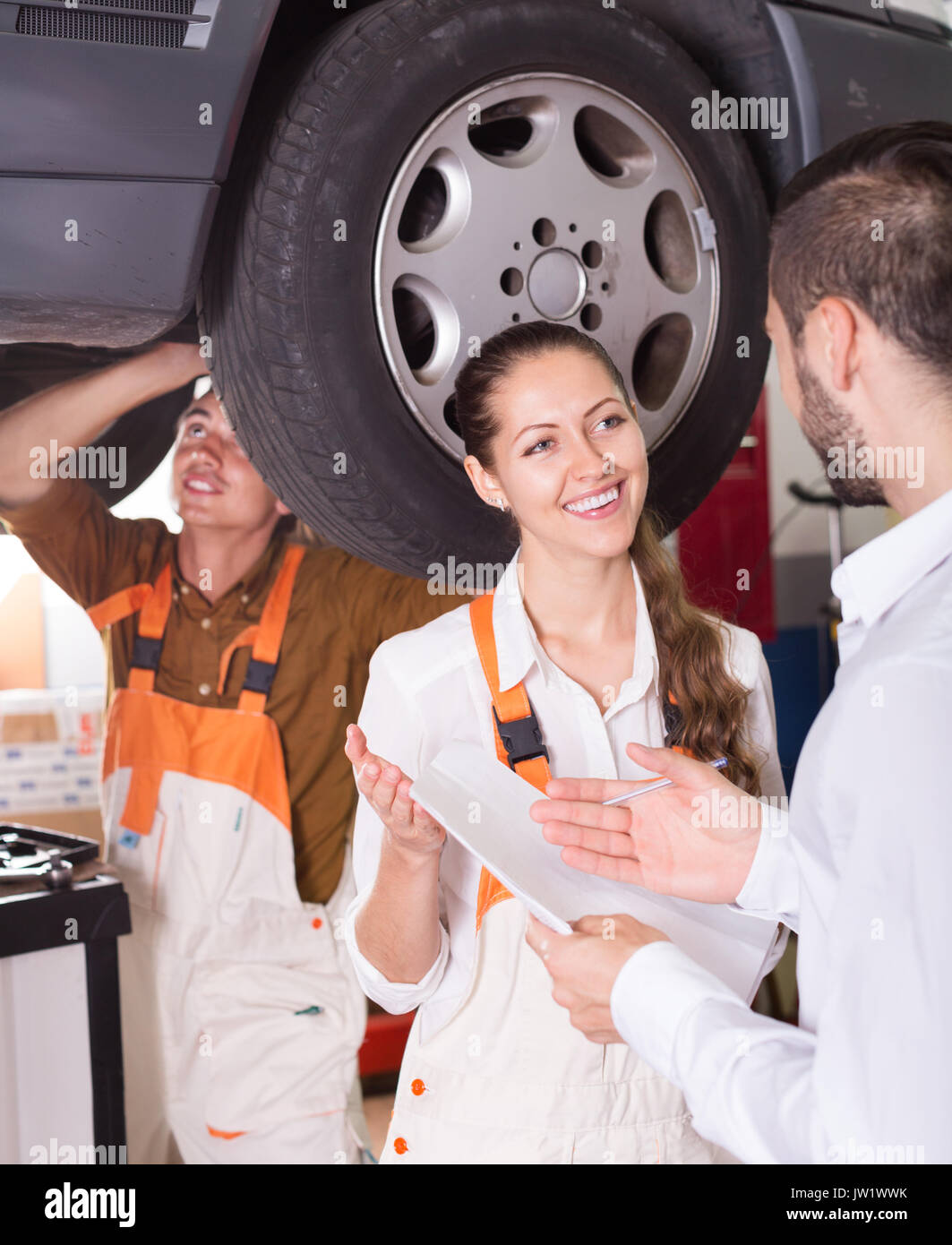 Two troubleshooters working with the car, manager filling documents ...