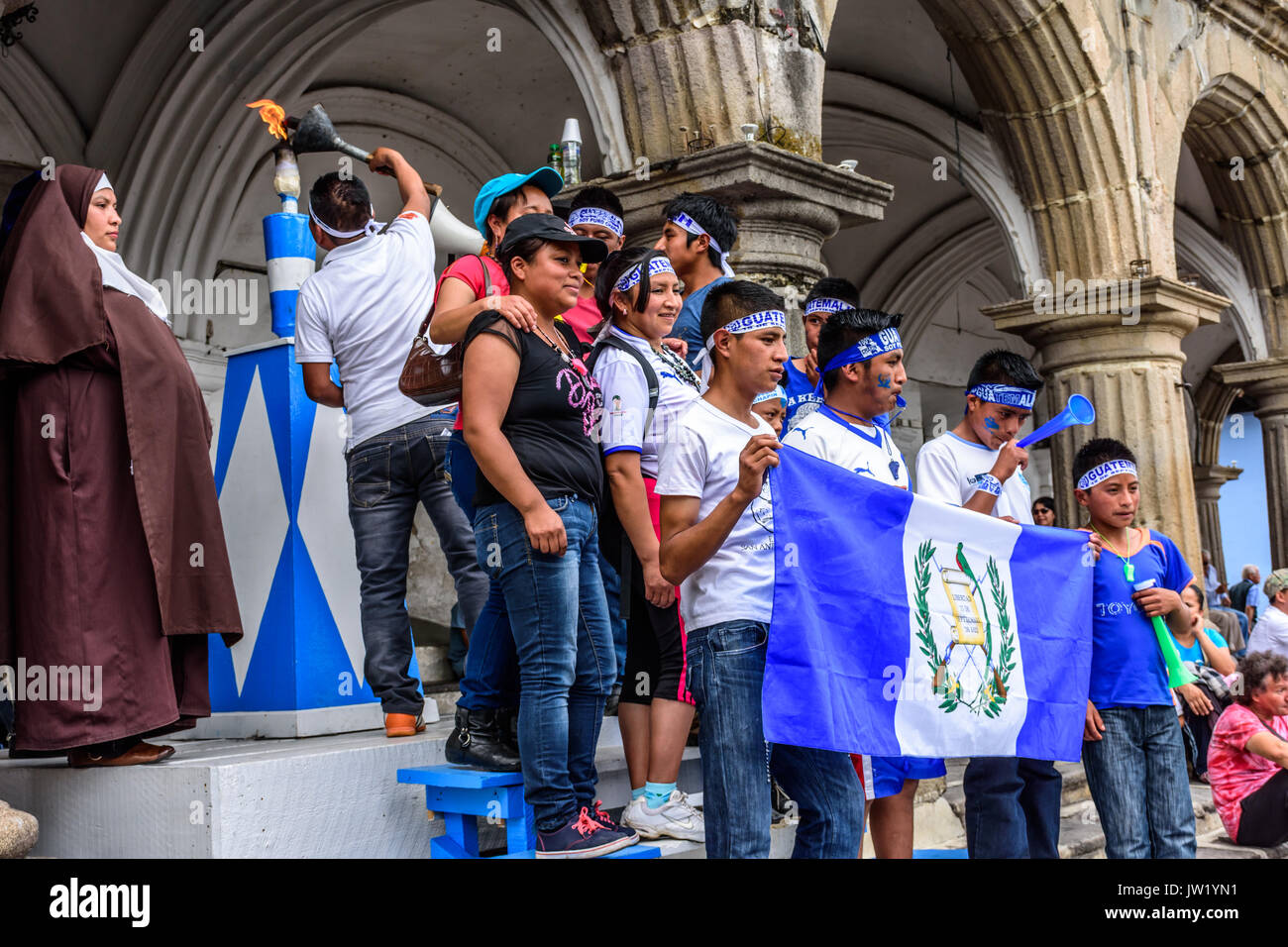 Antigua, Guatemala - September 14, 2015: Locals light torch & pose for photos with Guatemalan flag during Guatemalan Independence Day celebrations Stock Photo