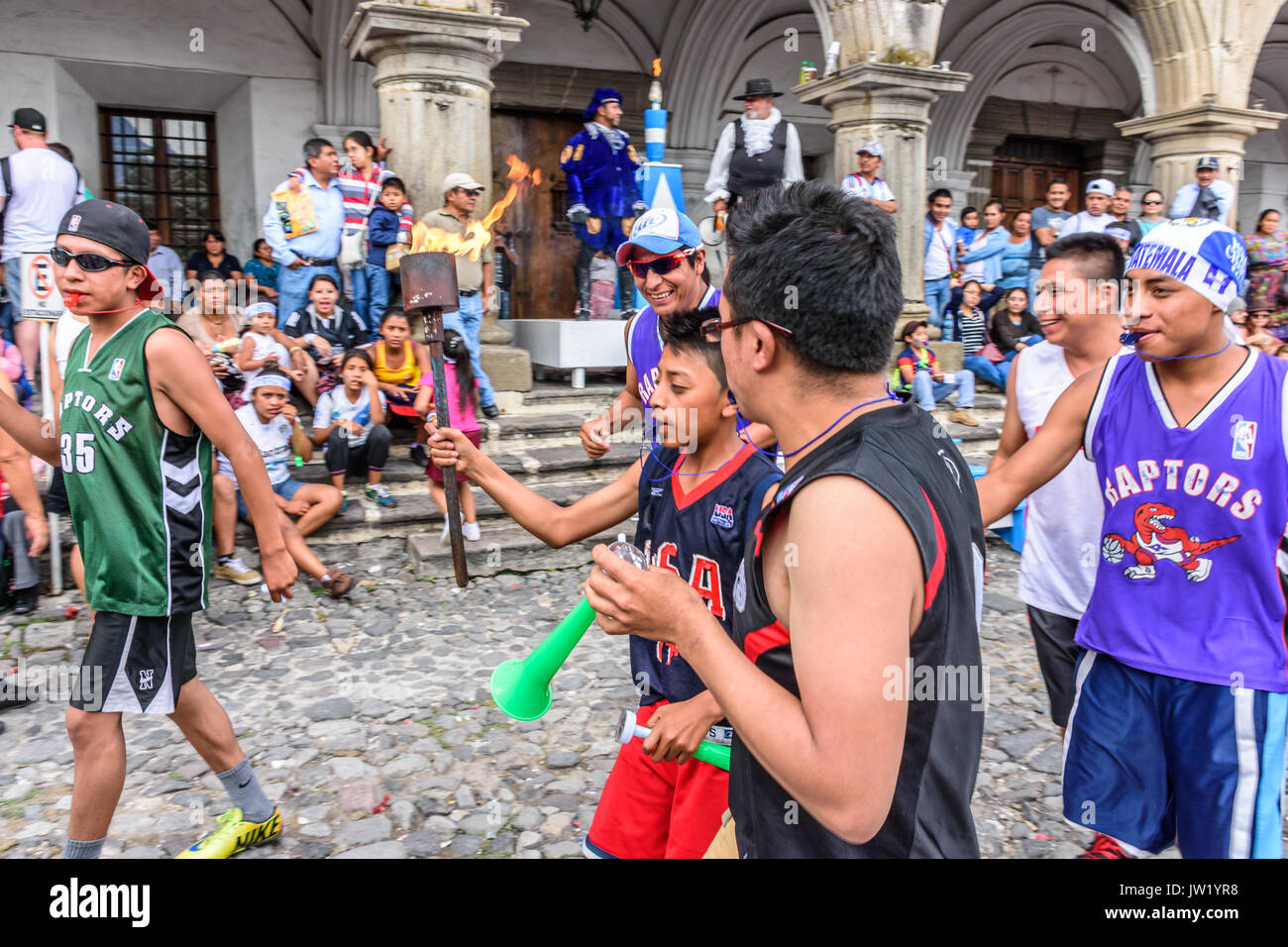 Antigua, Guatemala - September 14, 2015: Locals run with lit torches & blow whistles & horns during Guatemalan Independence Day celebrations Stock Photo