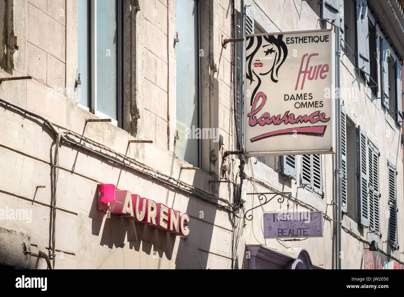 Old fashioned signs above hairdresser in Carcassonne, France Stock