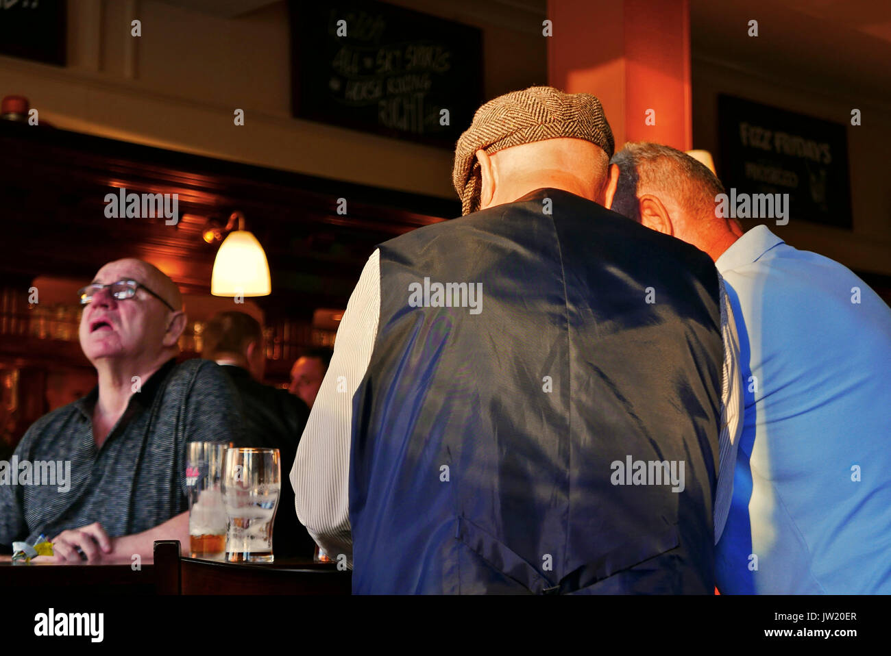 Three Men In Northern Pub Have A Quiet Chat Stock Photo Alamy