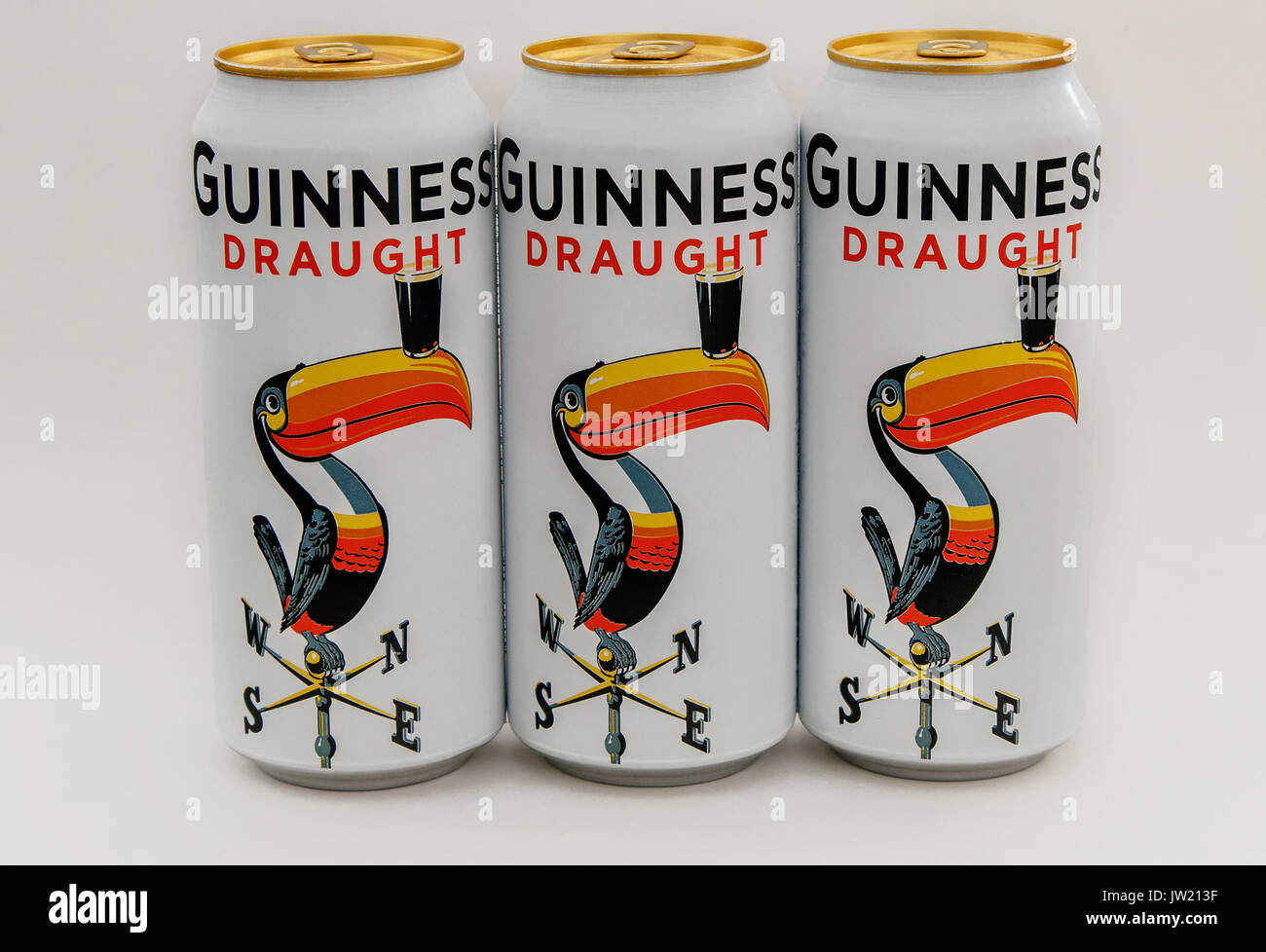Three limited edition Guinness beer cans stand against white background. Stock Photo
