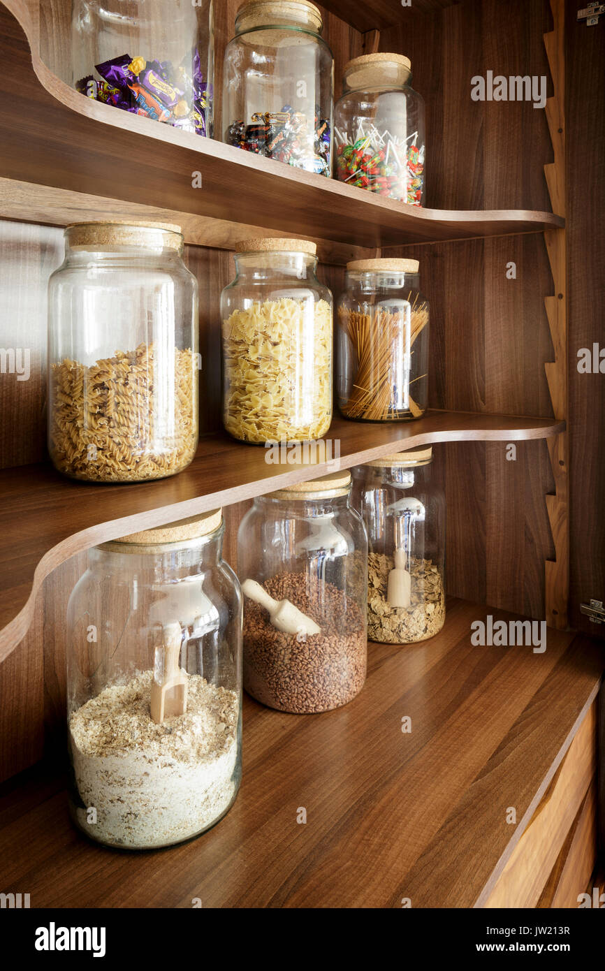 Storage jars on modern wooden kitchen shelving Stock Photo Alamy