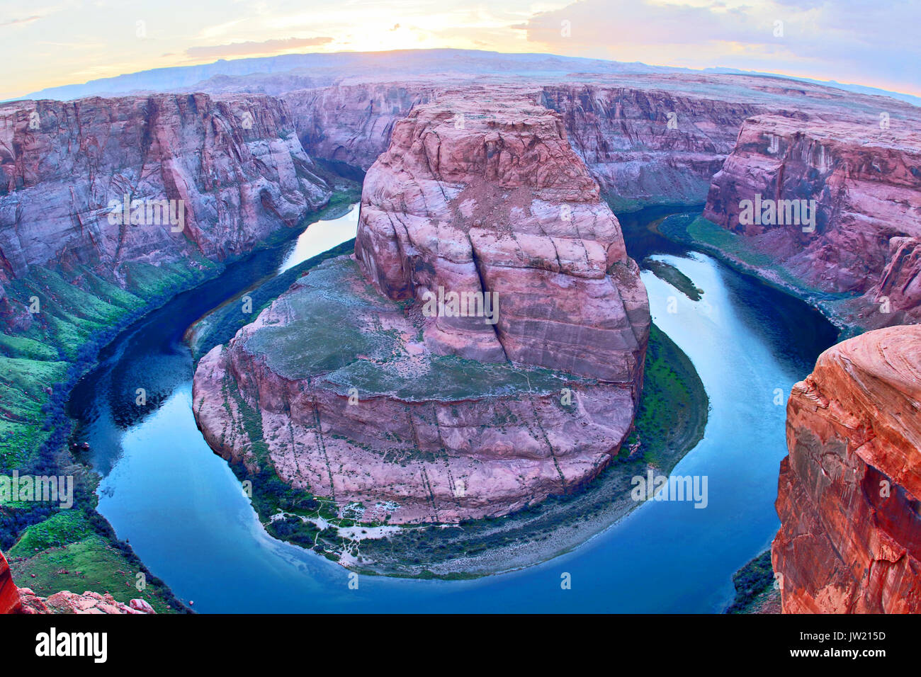 Dramatic bend of the Colorado River at the Horseshoe Bend close to the City of Page, Arizona, USA. Picture taken shortly after sunset with a fisheye l Stock Photo