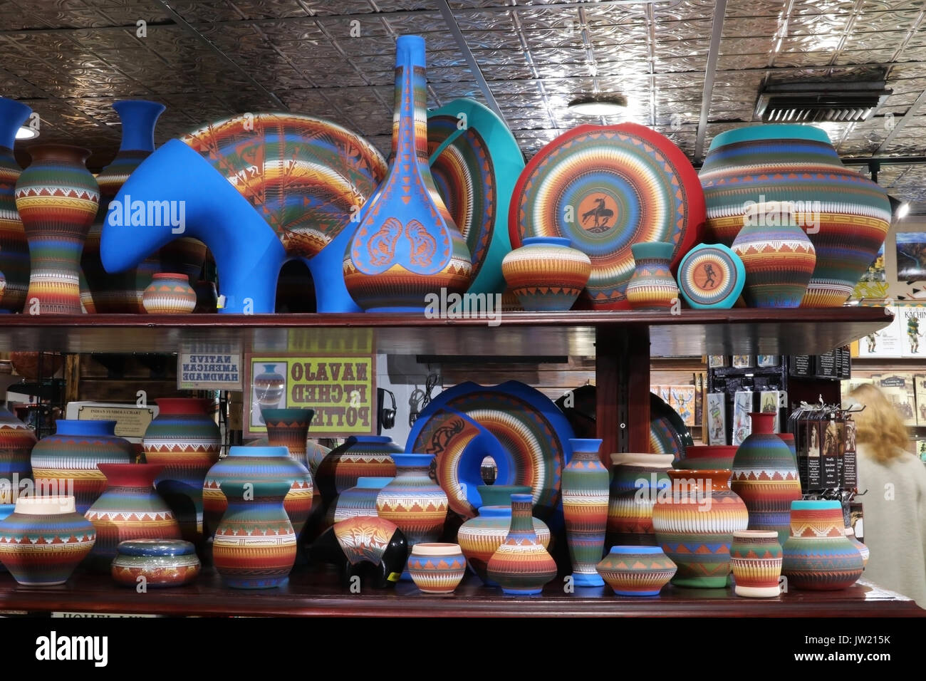 Shelves with hand made by native american souvenirs at historic trading post. Native american craft and culture background. Navajo etched pottery. Gra Stock Photo