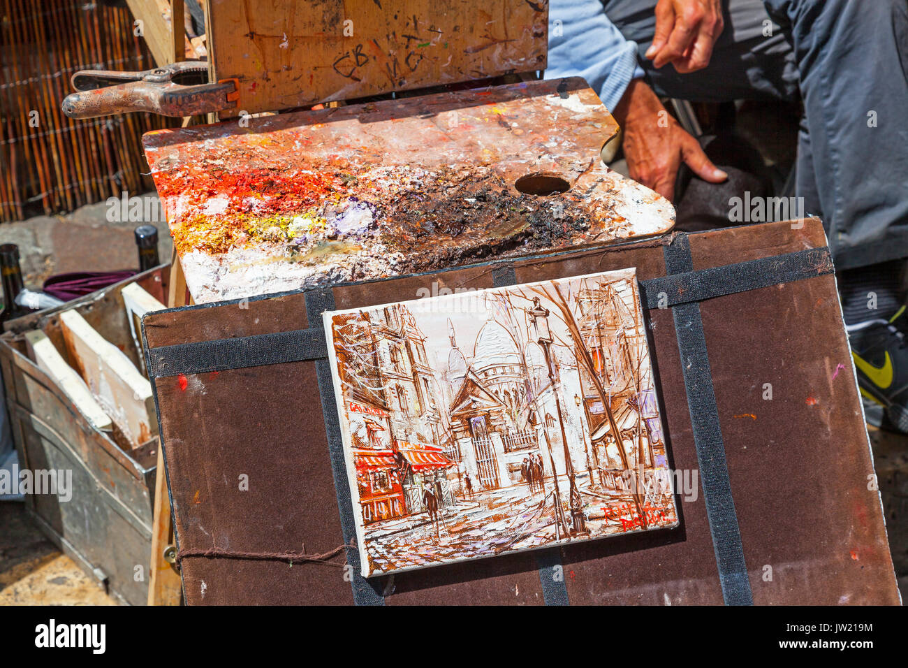 An artist's colorful palette and painting, in autumn shades of orange, red and brown, in Montmartre in Paris. Stock Photo