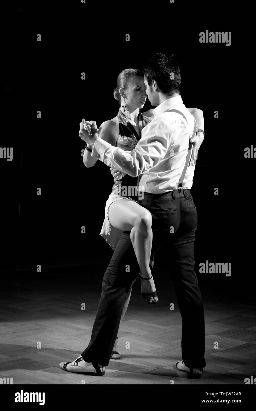 Beautiful dancers performing an argentinian tango dance. Black and white image for more effect. Stock Photo