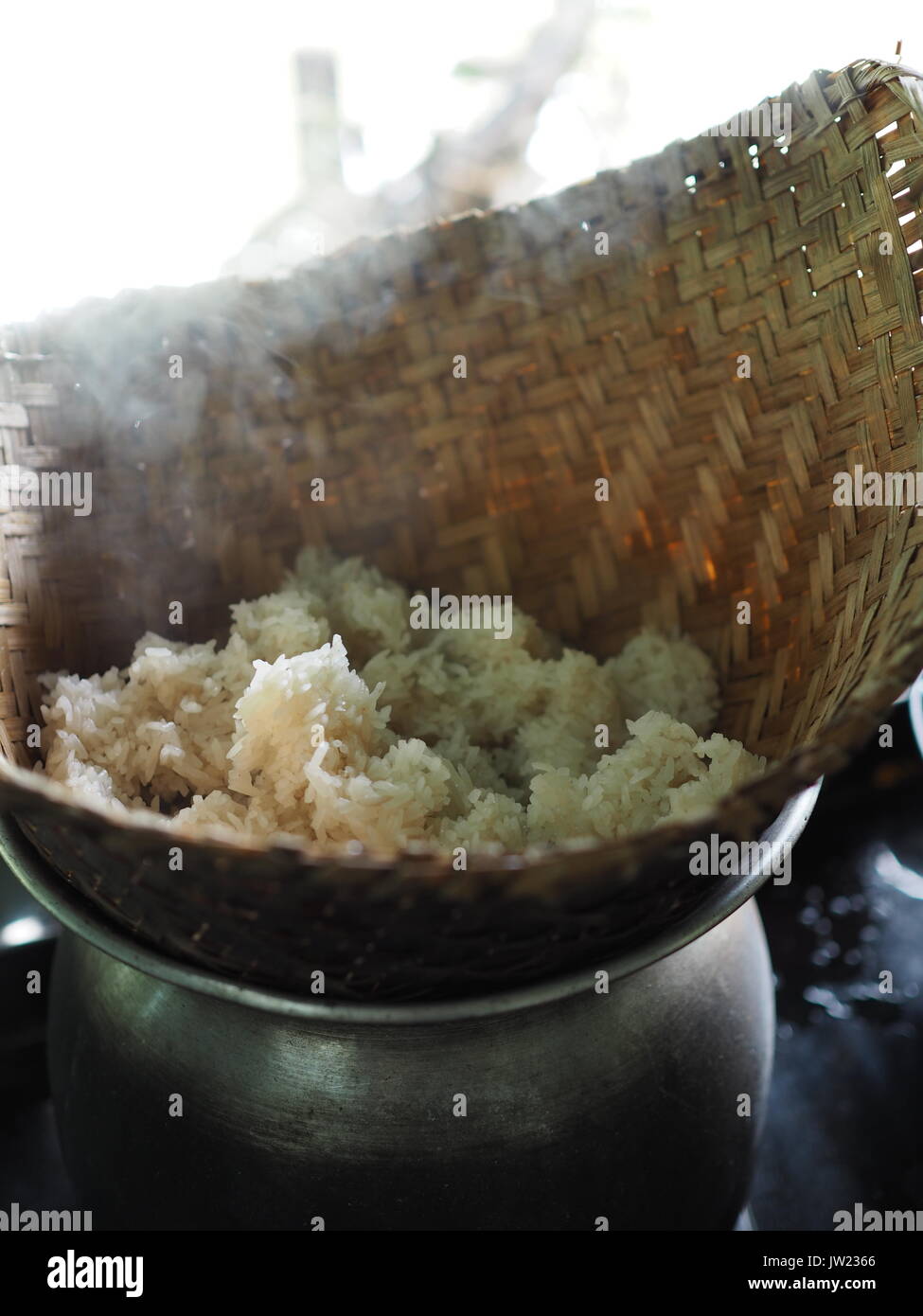 Sticky rick being cooked in a bamboo container over the steam in