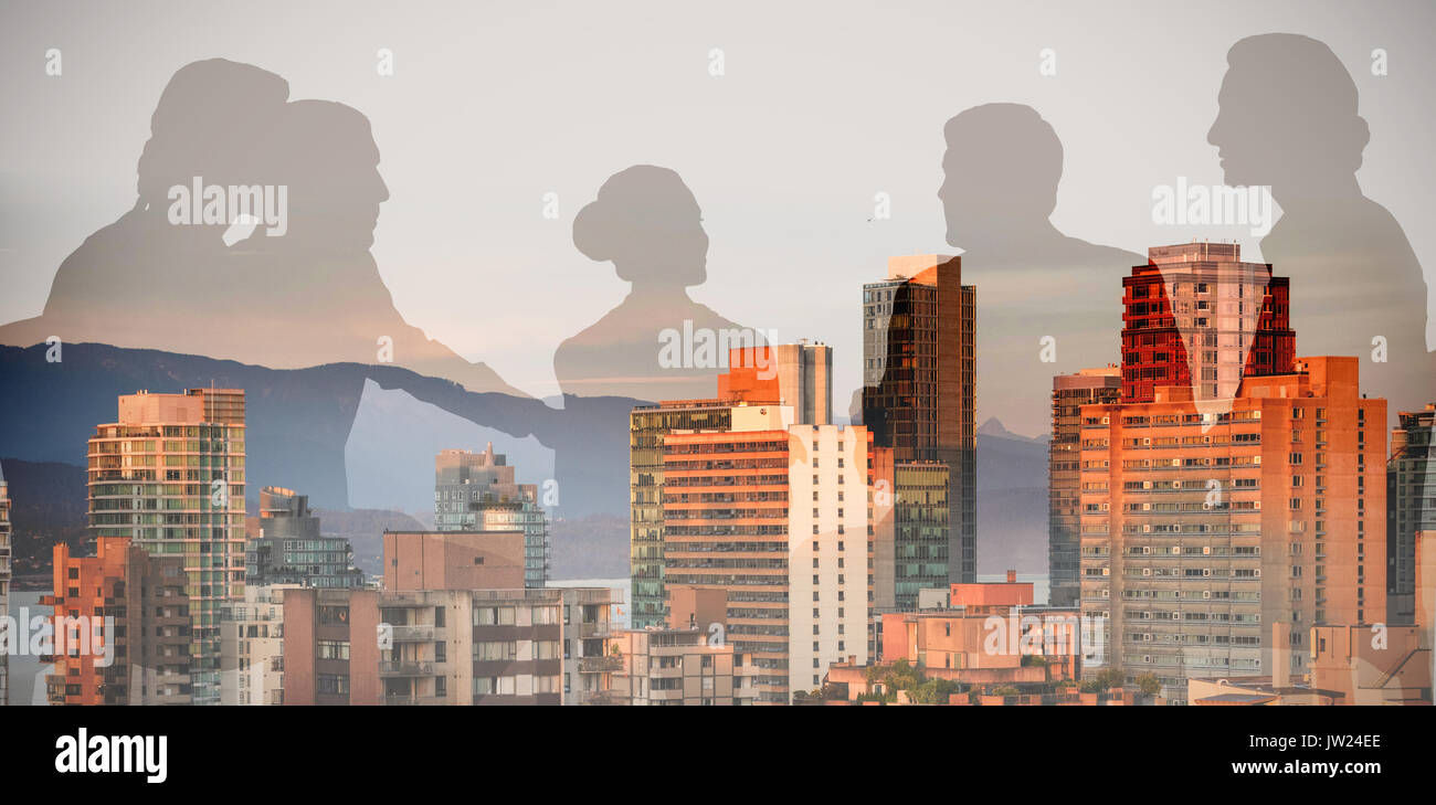 Silhouettes sitting against modern buildings in city Stock Photo