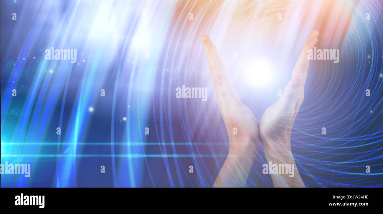 Hands gesturing against white background against background with shiny spiral Stock Photo