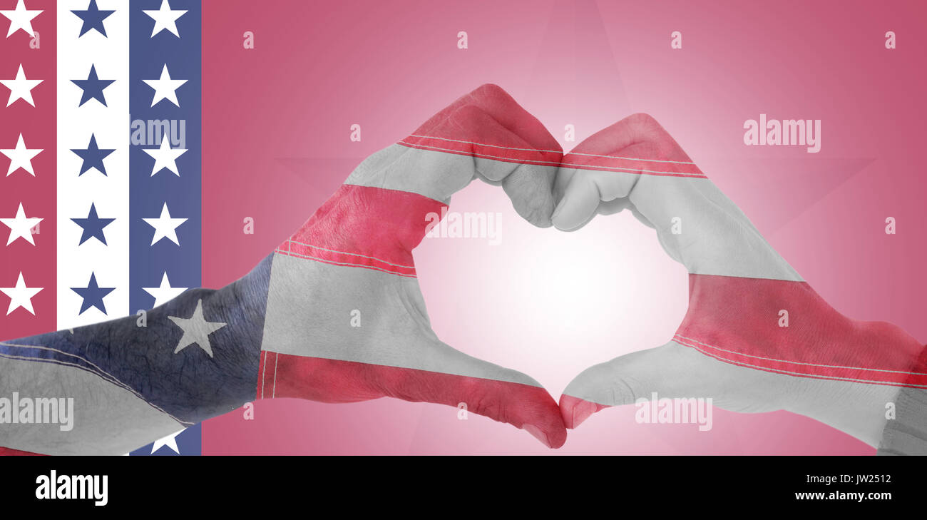 Couple making heart shape with hands against close-up of an flag Stock Photo