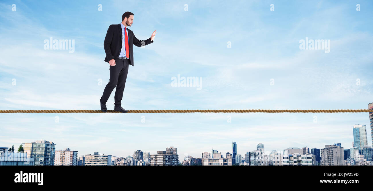 Businessman walking and presenting with hands against high angle view of roads in city Stock Photo