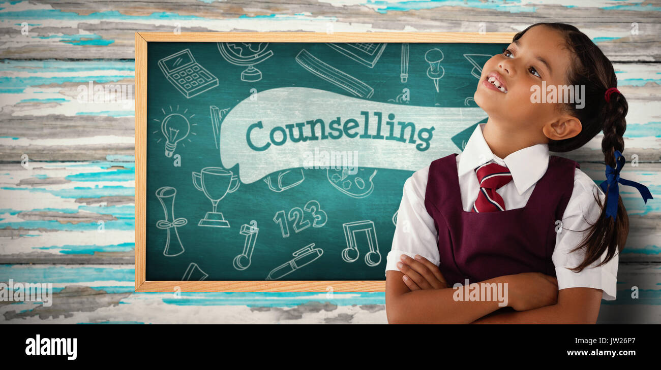 Thoughtful schoolgirl looking away against counselling against green chalkboard Stock Photo