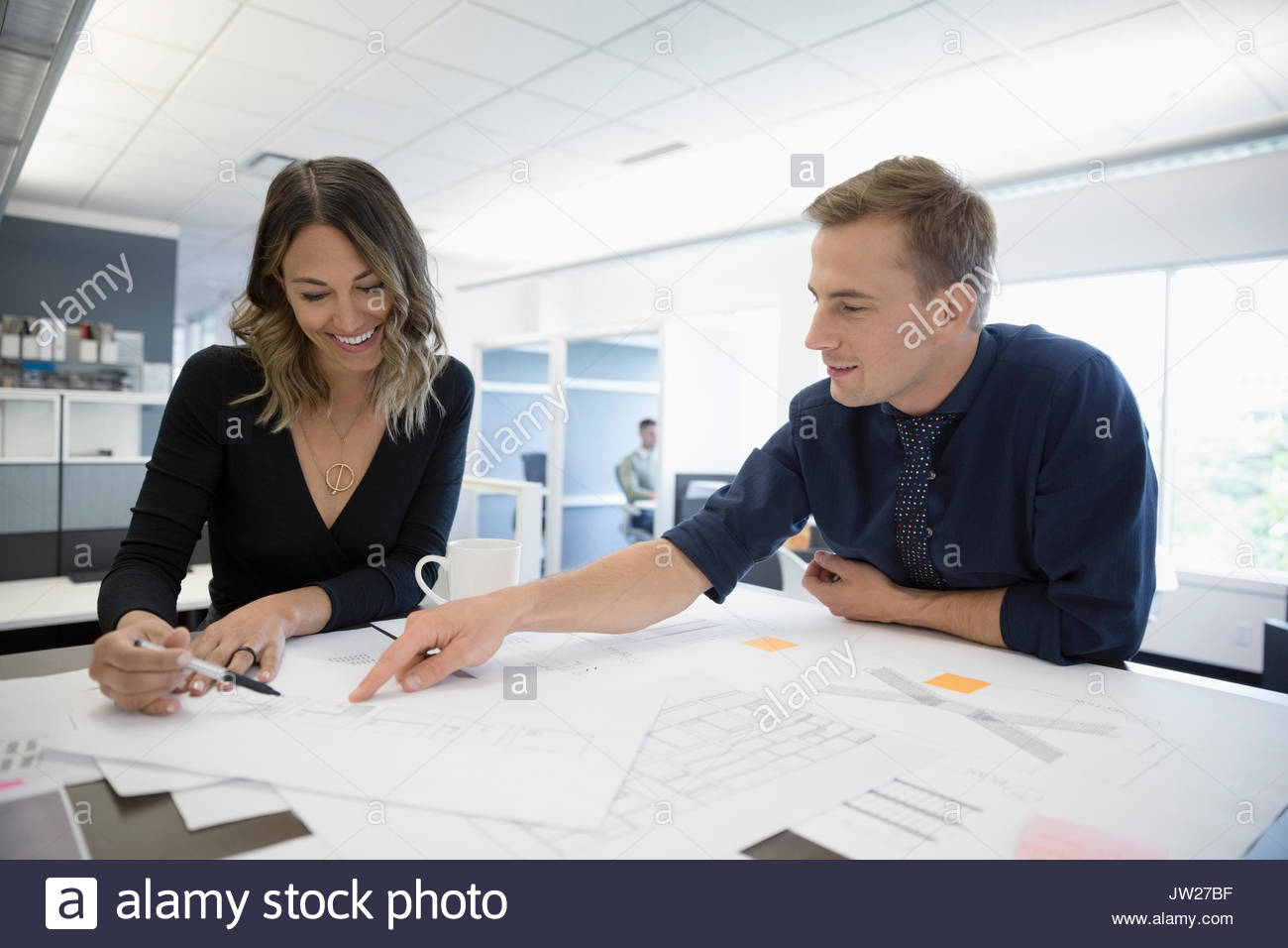 Reviewing blueprints at table hi-res stock photography and images - Alamy