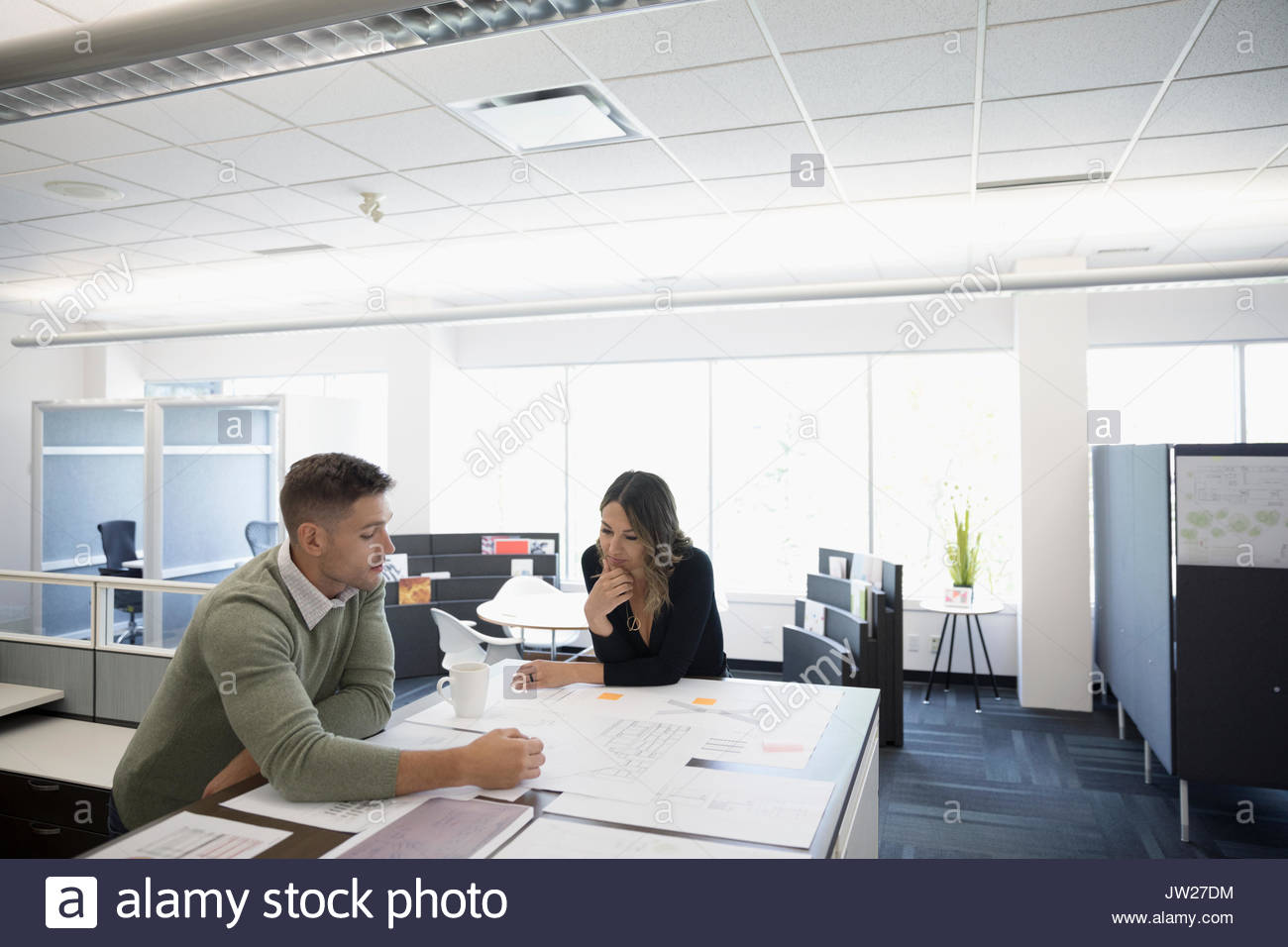 Reviewing blueprints at table hi-res stock photography and images - Alamy