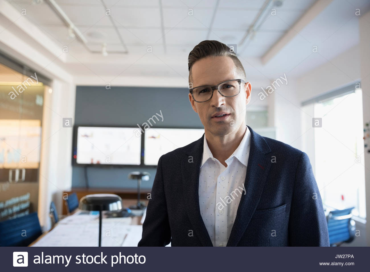 Portrait confident businessman in conference room Stock Photo