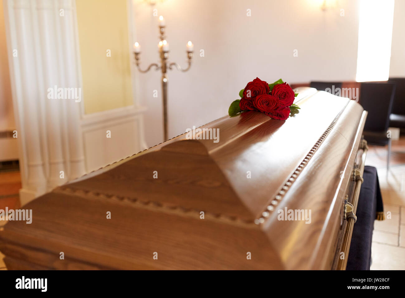 red rose flowers on wooden coffin in church Stock Photo Alamy