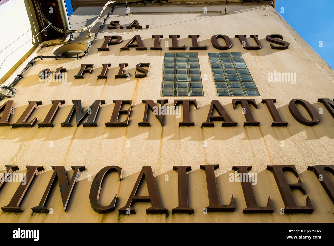 Old wall sign for ironmonger's shop, Monein, Pyrénées-Atlantiques, France. Stock Photo