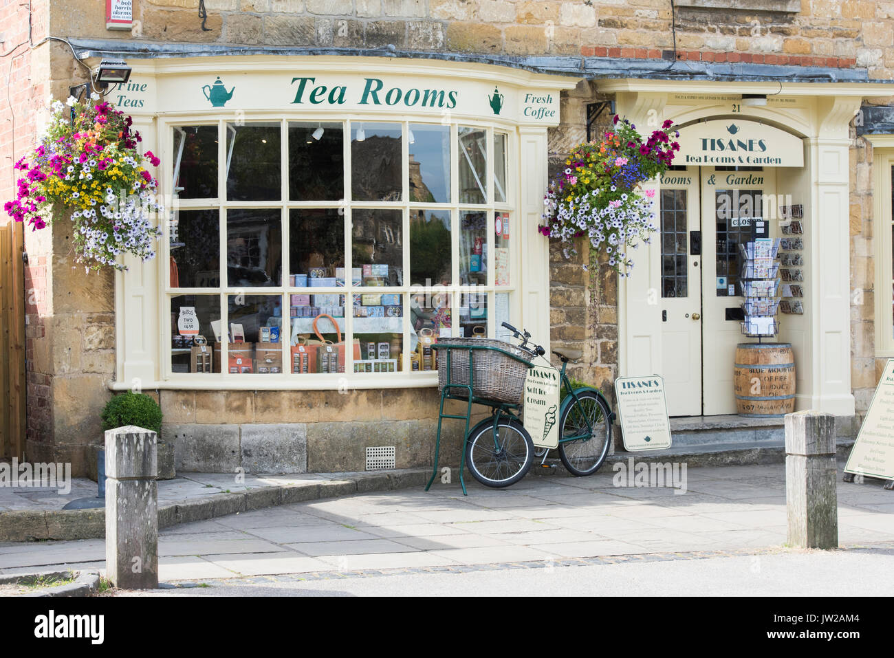 Summer floral hanging baskets outside Tisanes Tea Rooms, Broadway