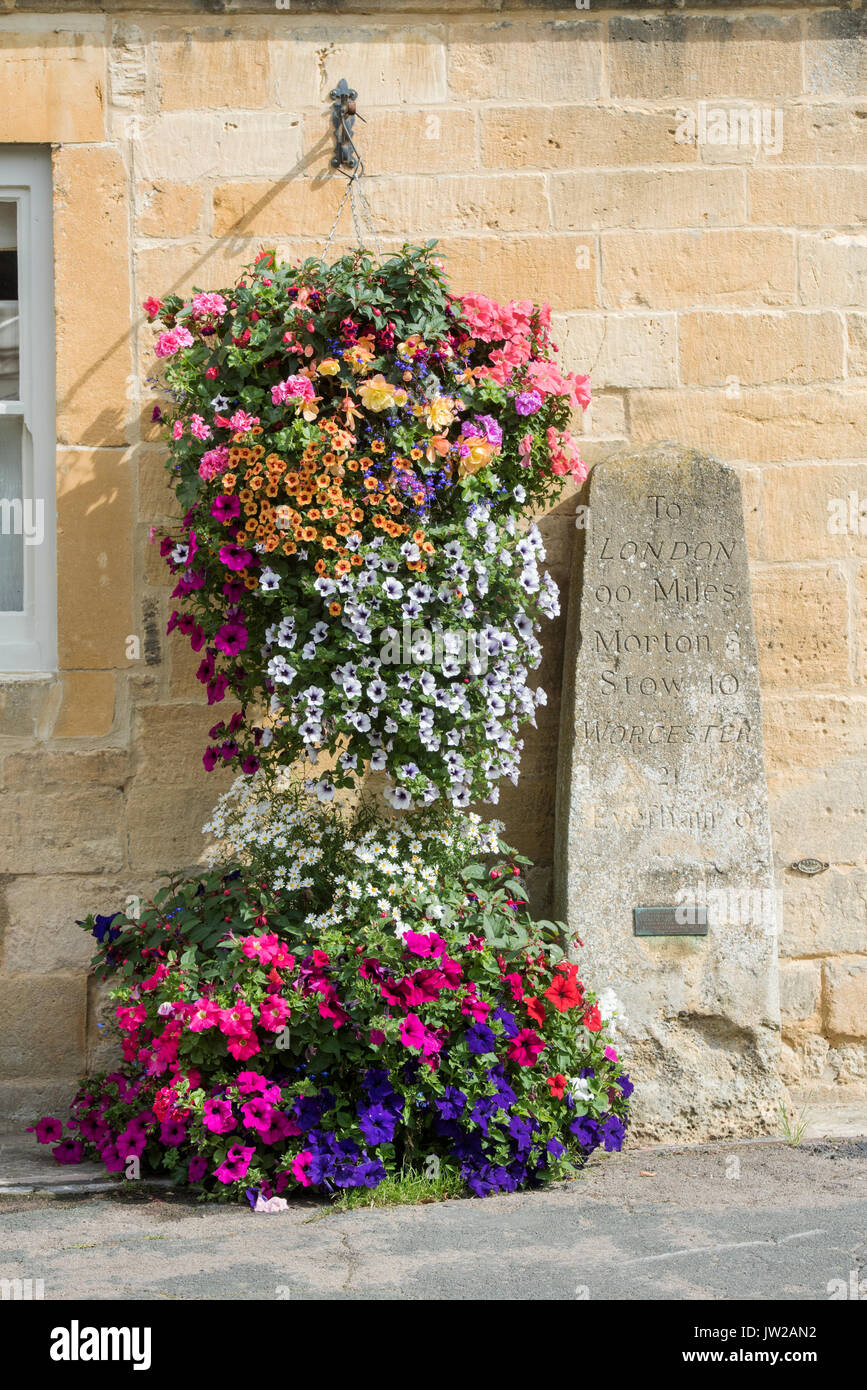 Petunia flowers in hanging baskets on the exterior of Milestone house