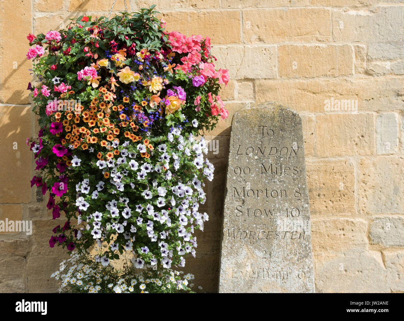 Petunia flowers in hanging baskets on the exterior of Milestone house