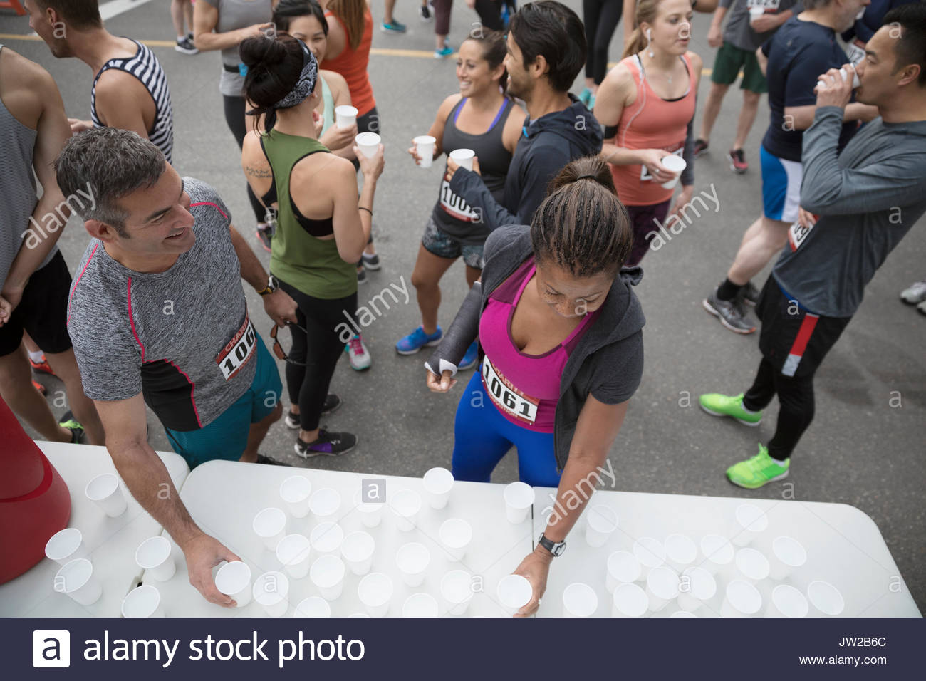 Marathon runners drinking water at water station Stock Photo Alamy