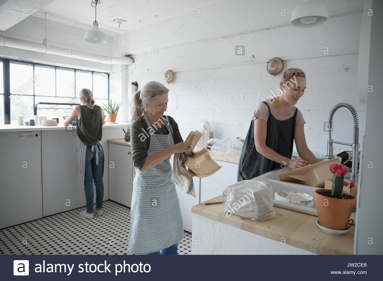 Female potters cleaning equipment in art studio Stock Photo Alamy