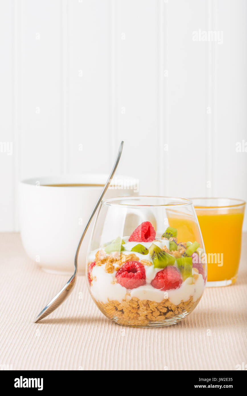 Delicious fruit parfait served with coffee and orange juice. Stock Photo