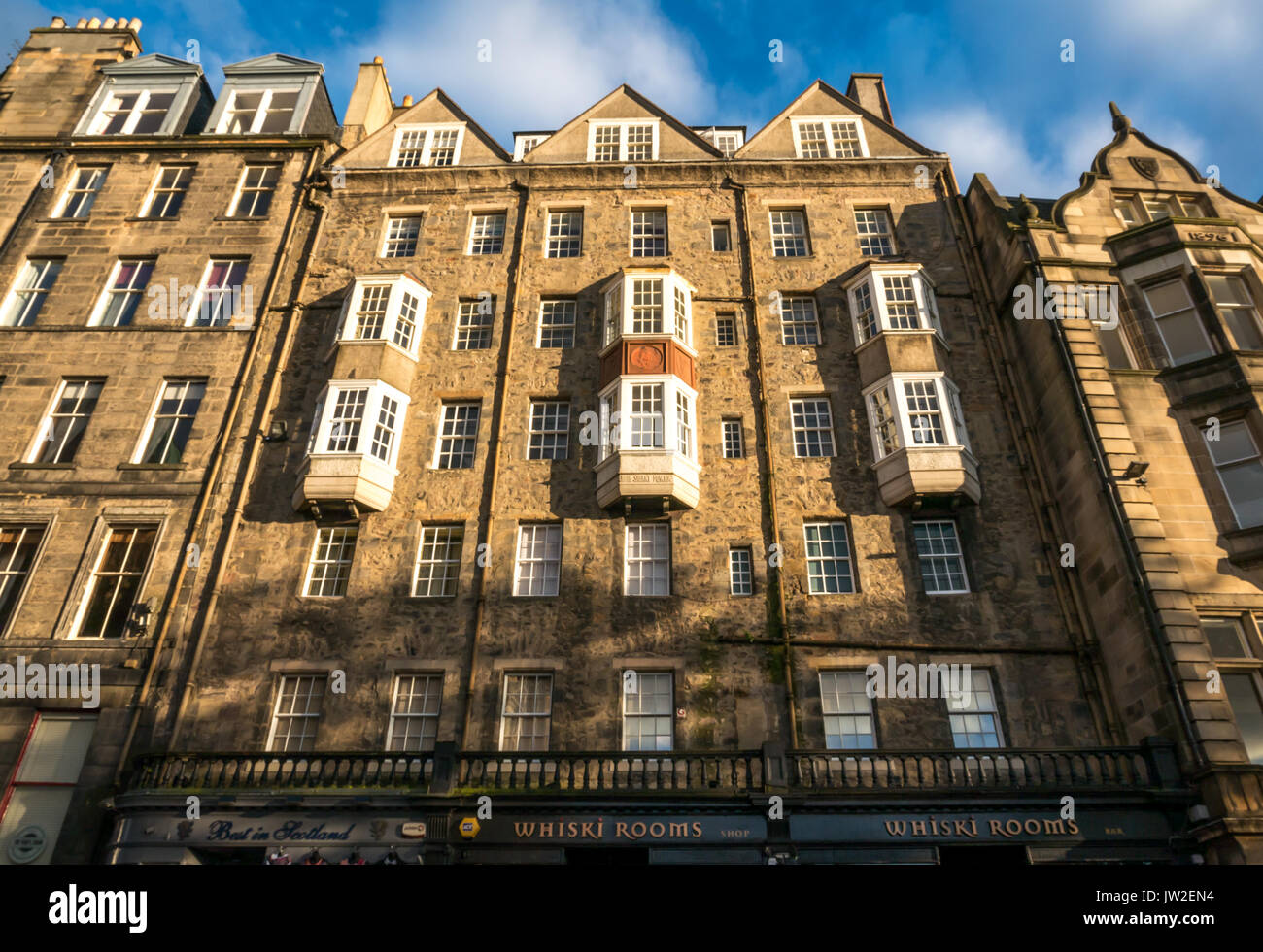 View of high storey tenement building, The Mound, Edinburgh, Scotland, UK, with added balcony windows, and reflected sun light Stock Photo