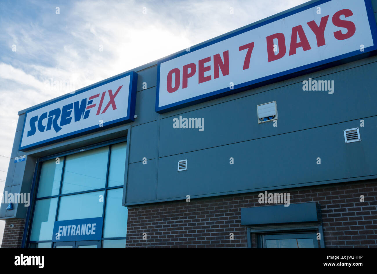 Screwfix shop store front against blue sky, with sign saying Open 7 Days, Seafield, Leith, Edinburgh, Scotland, United Kingdom Stock Photo