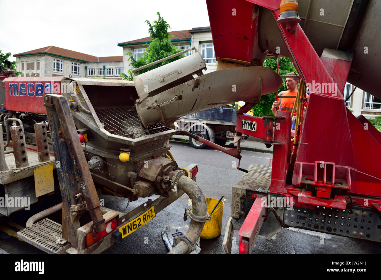 Close up of hopper on concrete pumping truck teamed up with a ready-mix cement mixer truck for a domestic refurbishment Stock Photo