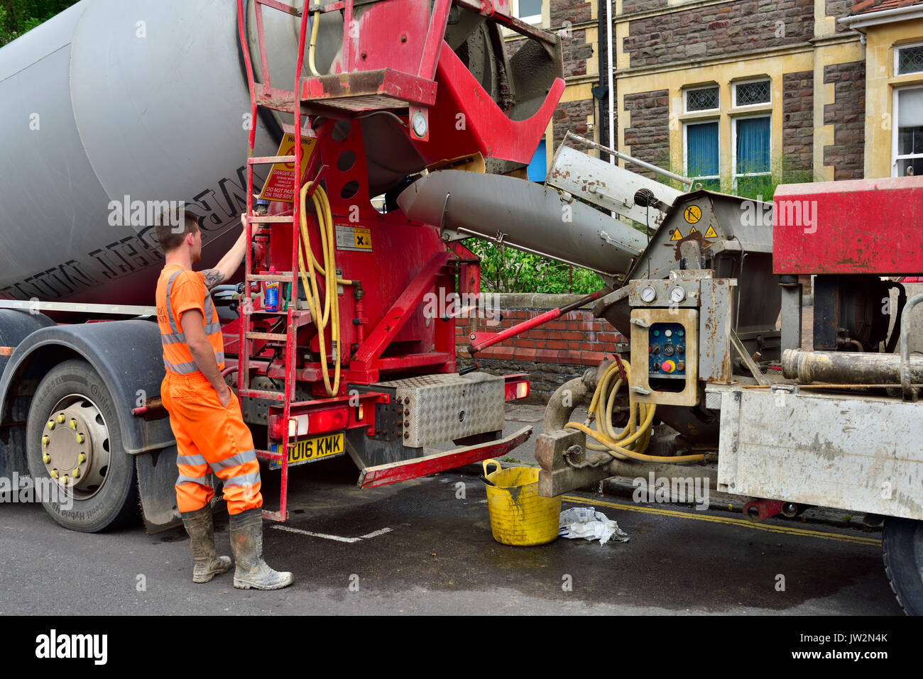 Concrete pumping truck teamed up with a ready-mix cement mixer truck for a domestic refurbishment Stock Photo