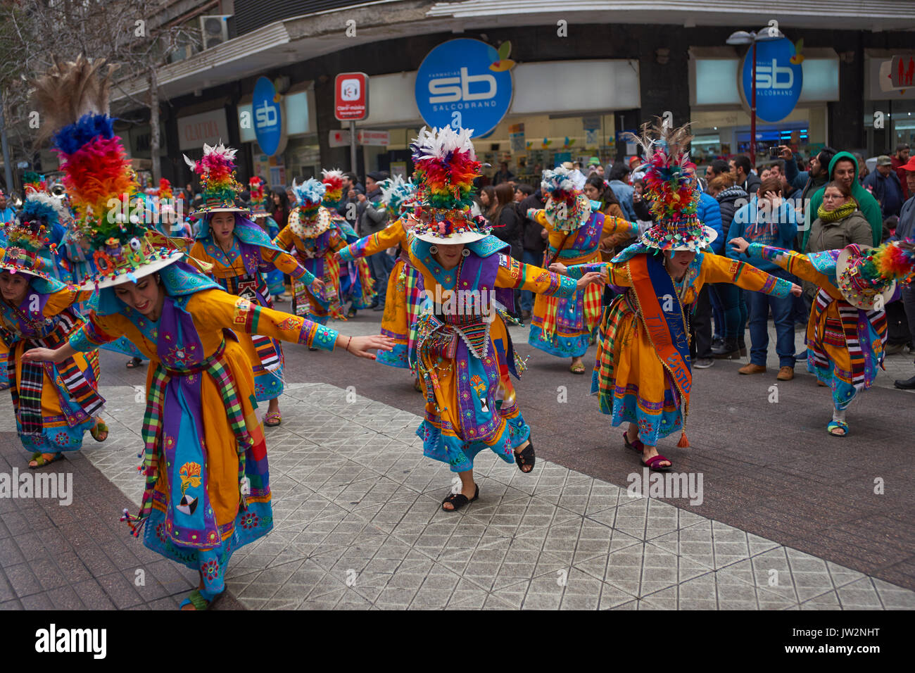 Tinkus dance group parading through the centre of Santiago, Chile to mark Independence Day of Bolivia. Stock Photo