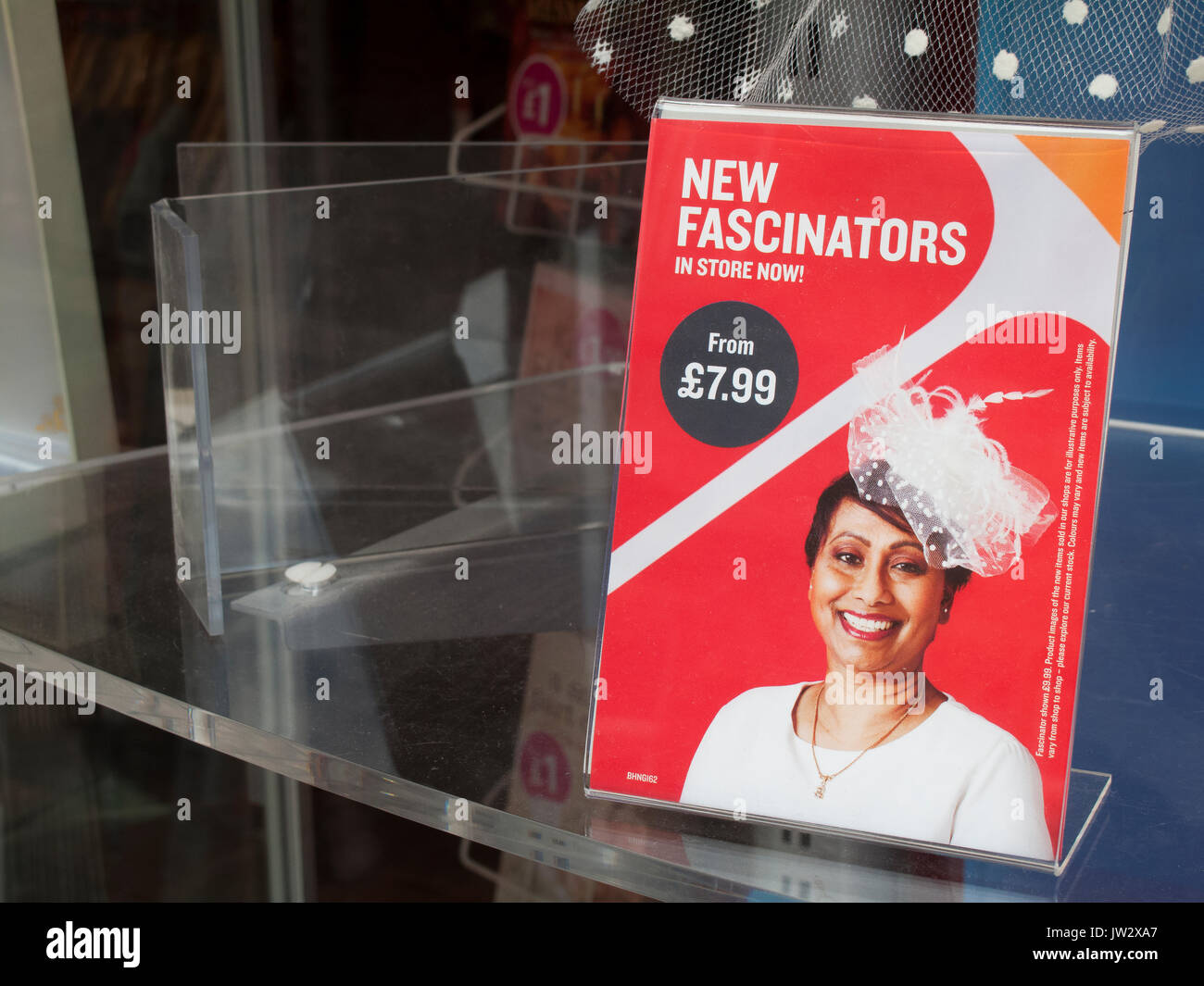 New fascinators in store now sign in retail shop window Stock Photo Alamy