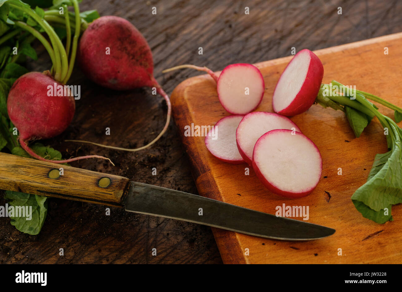 https://c8.alamy.com/comp/JW3228/slices-of-red-radish-and-knife-on-cutting-board-JW3228.jpg