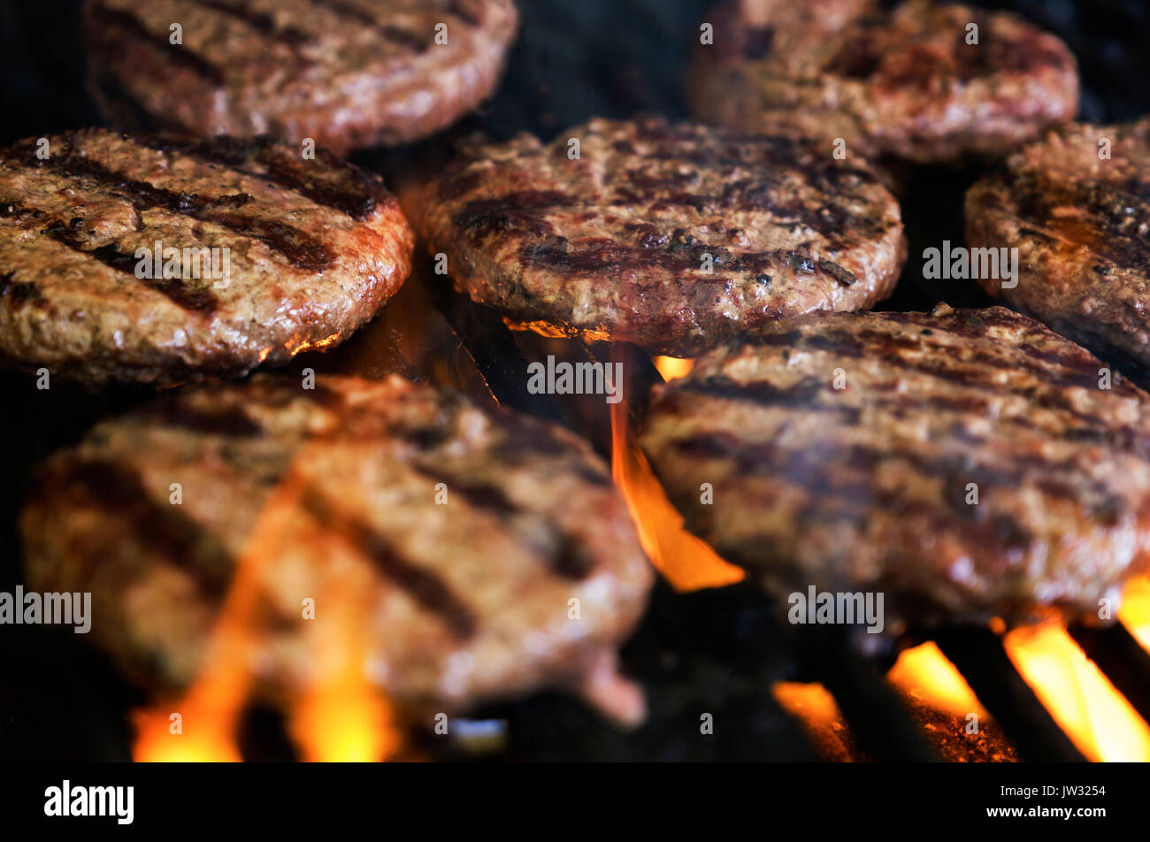 Hamburgers on barbeque grill Stock Photo