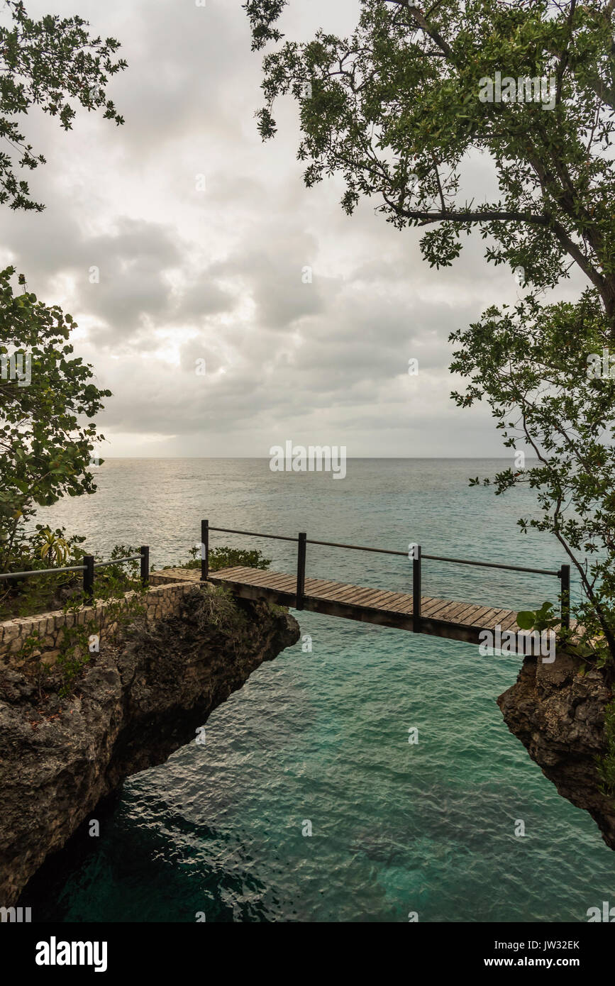 Jamaica, Negril, Footbridge hanging between rocks Stock Photo
