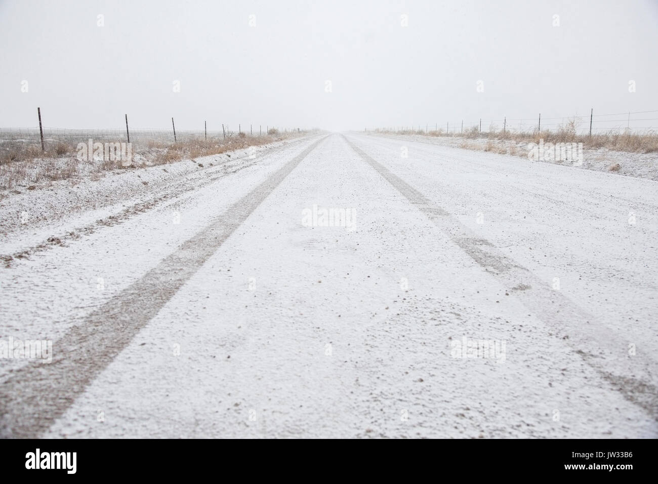 USA, Colorado, Empty dirt road covered with snow Stock Photo