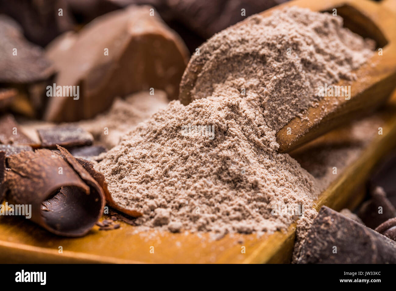 Still life with wooden scoop full with chocolate powder Stock Photo