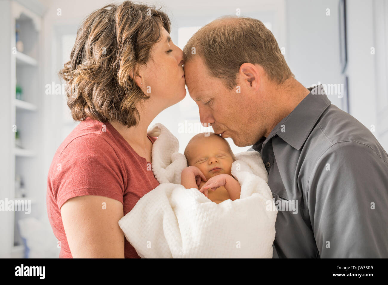 Parents holding and baby son (0-1 months) Stock Photo
