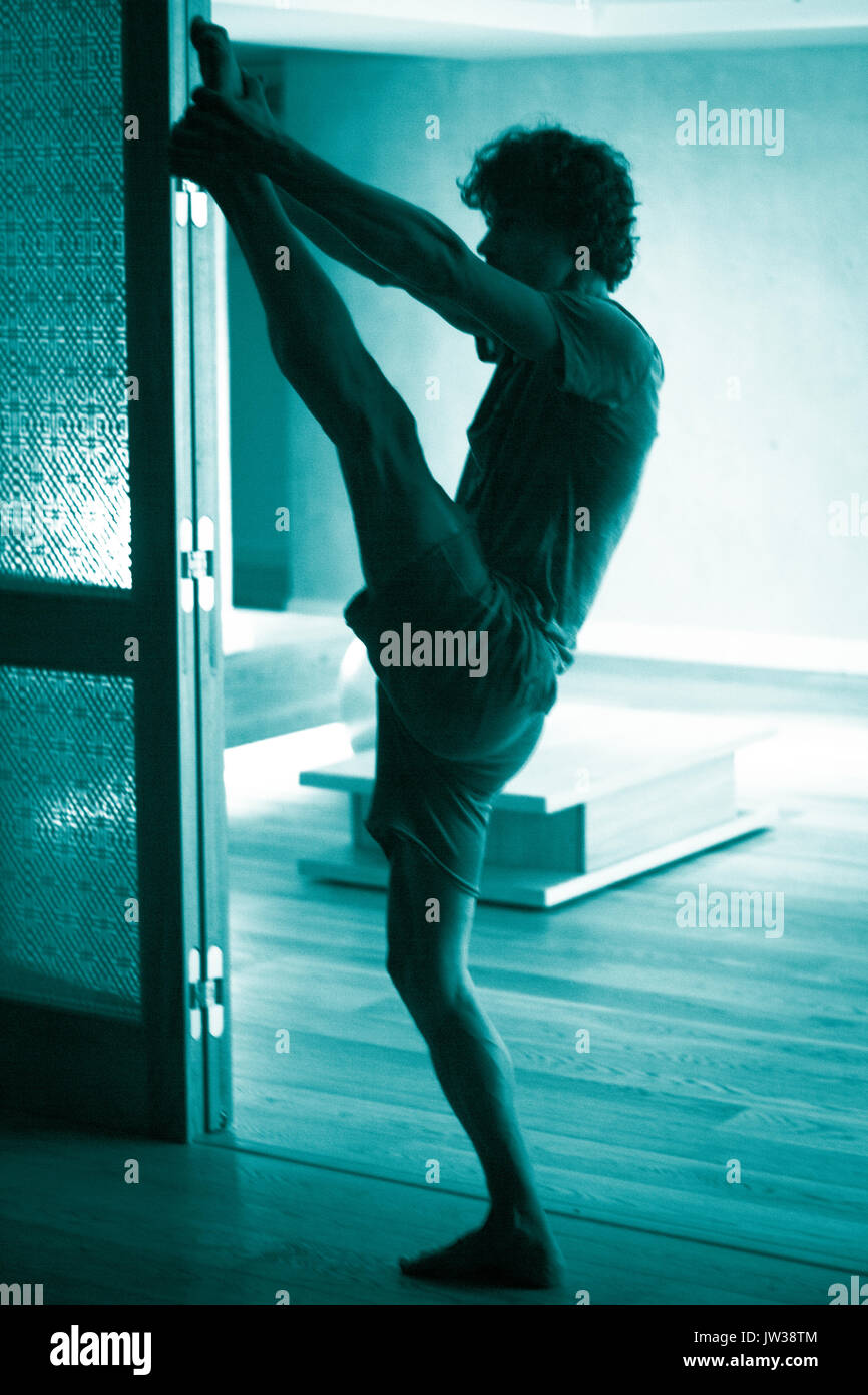 Male yoga teacher doing splits leg stretching flexibility calisthenics